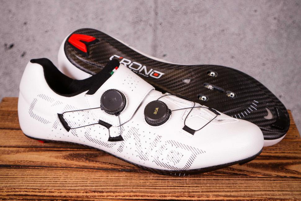 White Crono CR1 Carbon Road Shoes on wooden surface in a studio