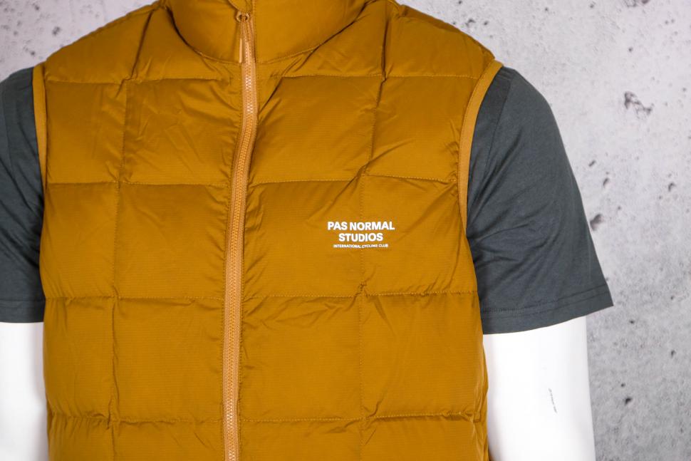 2022 Pas Normal Studios Men's Escapism Down Vest - chest logo.jpg