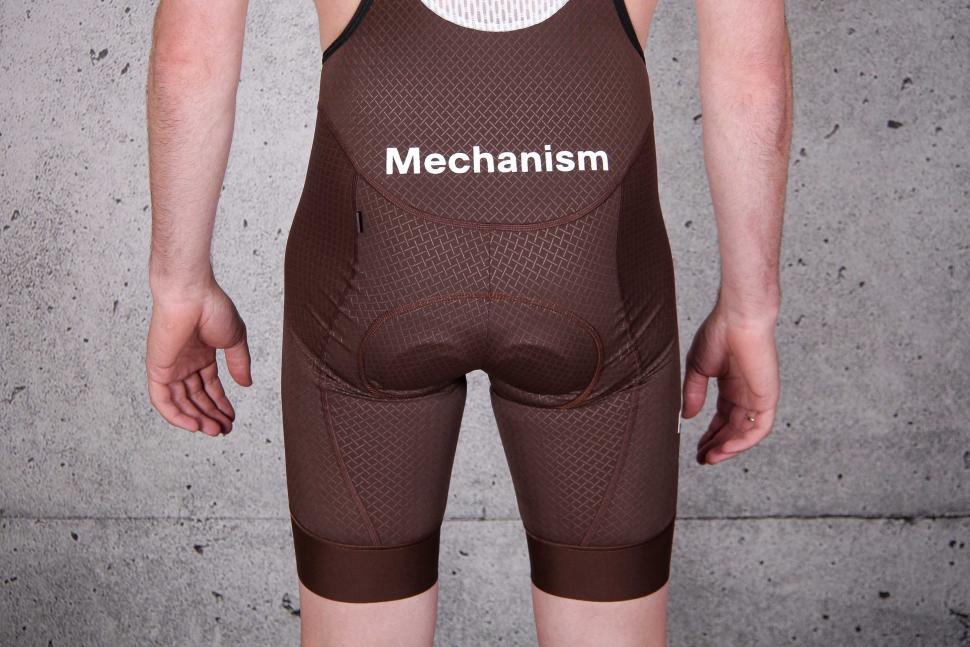 2022 Pas Normal Studios Men's Mechanism Bibs - Bronze - back legs.jpg