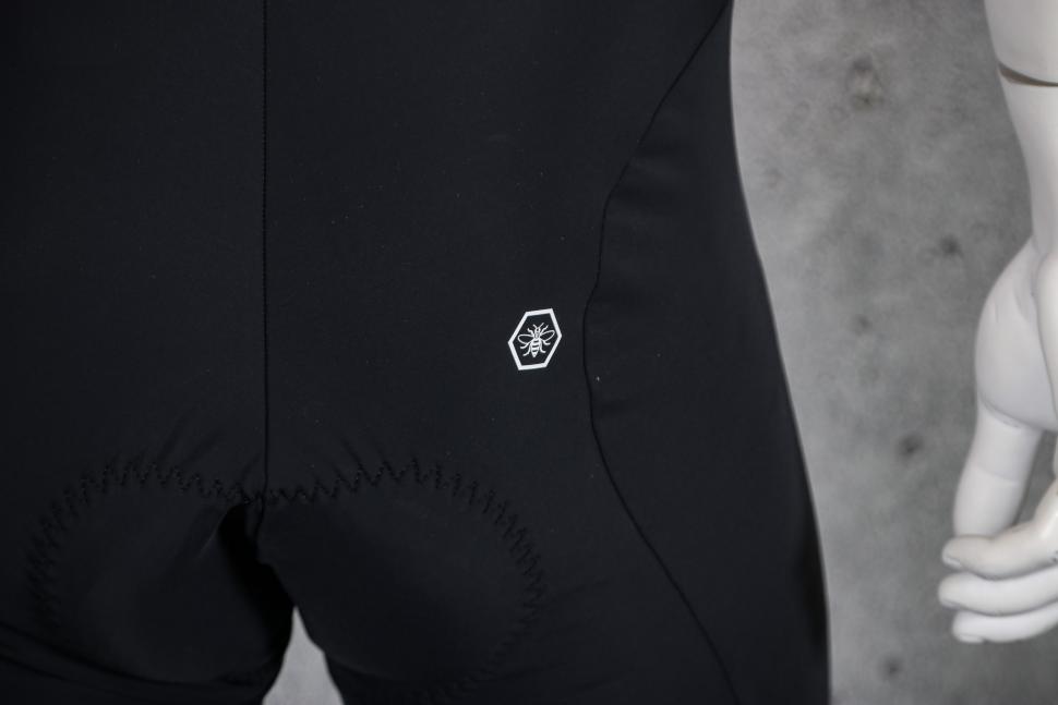 2023 Lusso Perform Carbon Bib Shorts - back logo.jpg