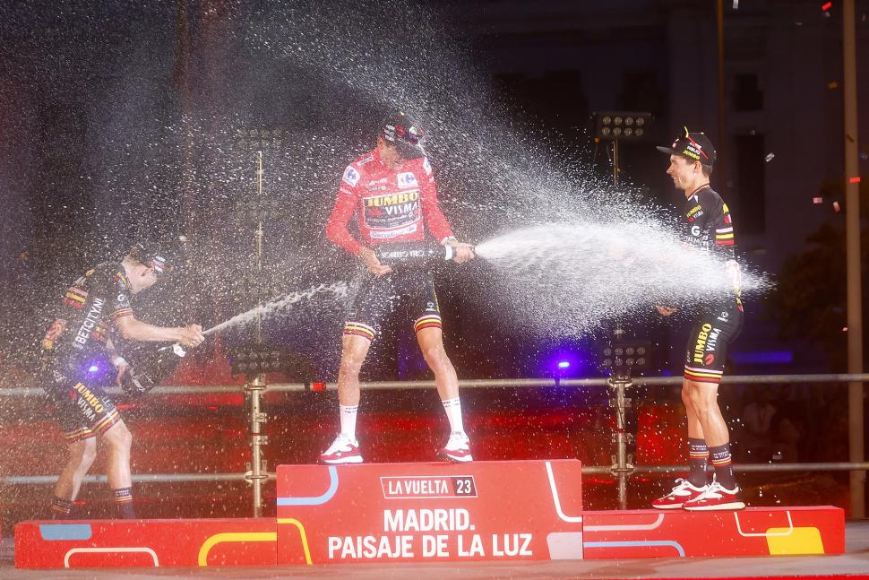 Sepp Kuss, Jonas Vingegaard, and Primož Roglič celebrate after stage 21, 2023 Vuelta a España (Rafa Gomez/SprintCyclingAgency)