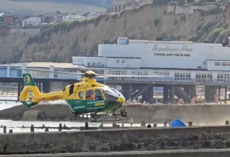 Air ambulance lands on beach to treat cyclist pushed off seawall in Sandown