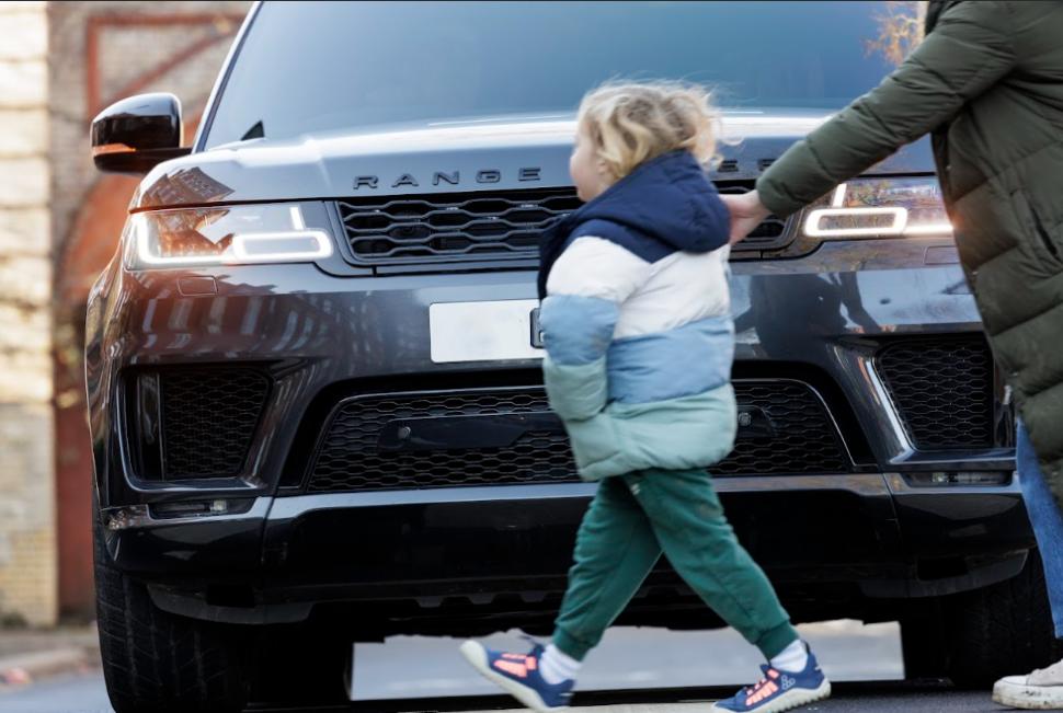 Child walking in front of SUV