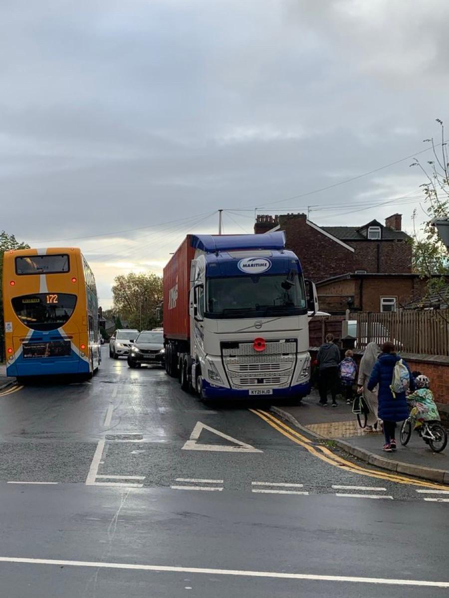 Children cycling to school on road and pavement blocked by lorries, Manchester (Stevie Zero, BlueSky)