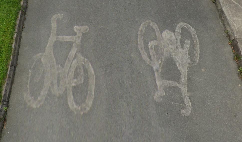 Bicycle symbols burnt off road after residents complained they were too confusing for drivers, Templeogue, Dublin (Google Street View)