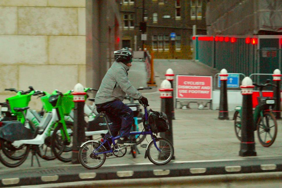Cyclist in London cyclists dismount sign in background - copyright Simon MacMichael