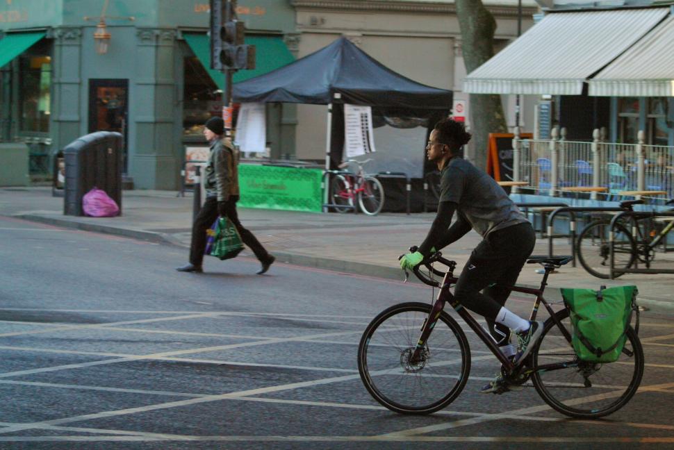 Cyclist in London on road bike with panniers - copyright Simon MacMichael