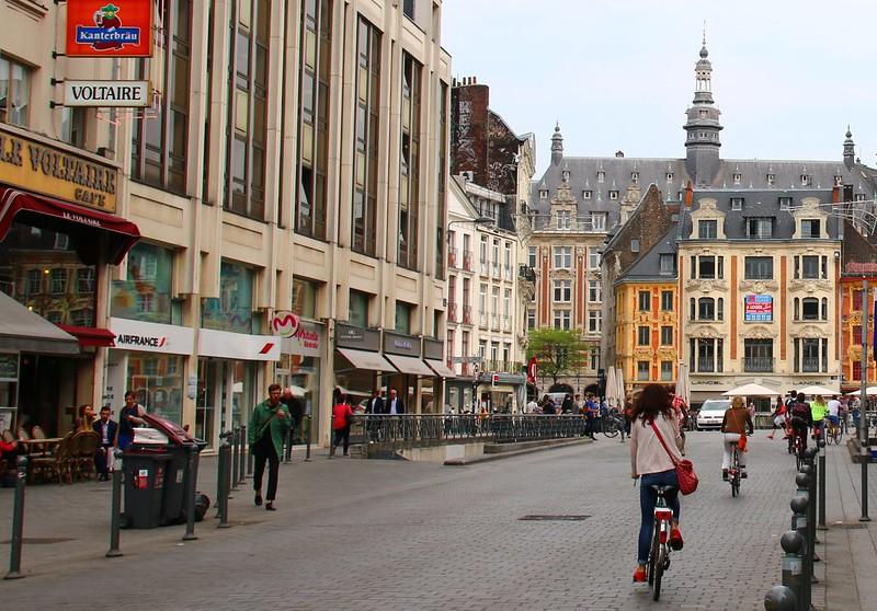 Cyclists in Lille's Grand'Place (licensed CC BY SA 2.0 by Alain Rouiller on Flickr)