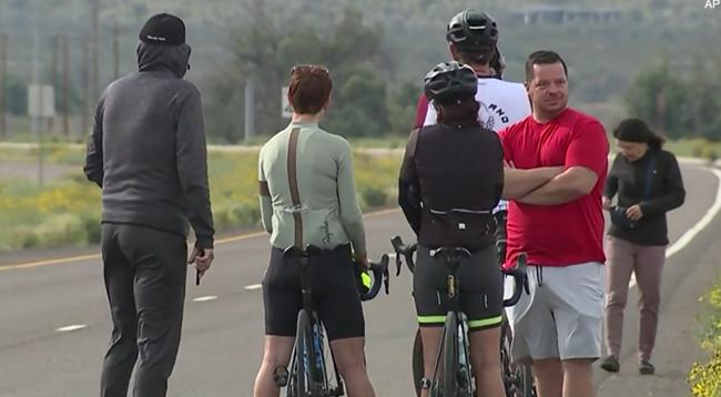 Cyclists wait near scene of collision involving group of riders and pickup truck driver in Arizona (Goodyear Police)