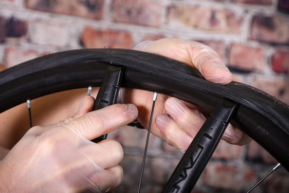 Fitting an inner tube - 06 - using a second tyre lever to work off the bead.jpg