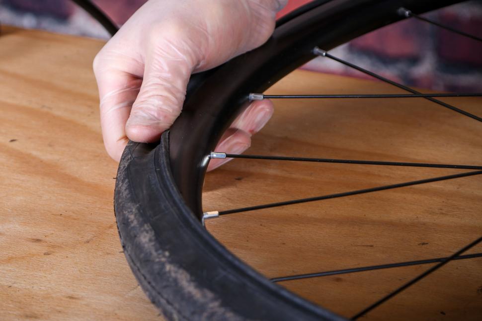 Fitting an inner tube - 17 - working the second bead onto the rim.jpg