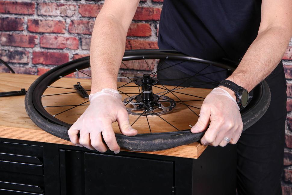 Fitting an inner tube - 22 - working on the final part of the tyre bead.jpg