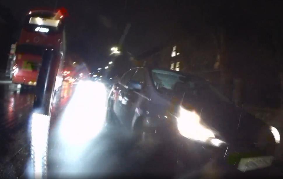 Motorist drives towards cyclists in cycle lane, Lower Road towards Surrey Quays, London