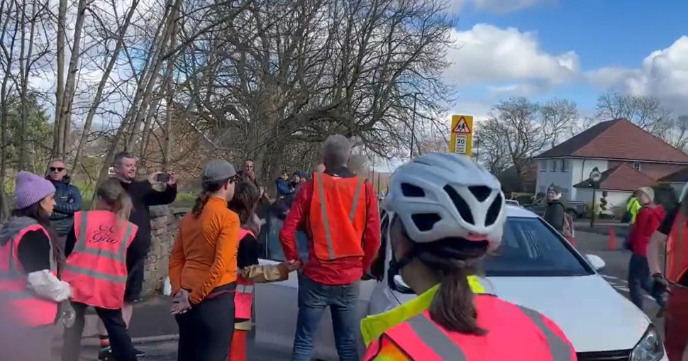 Motorist mounts pavement and attempts to drive through ‘die-in’ in Sheffield (credit - llamasteve, Twitter)