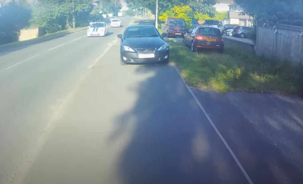 Motorist parked blocking shared cycle and pedestrian path tells cyclist to “get on the road” (Adrian Chapmanlaw, YouTube)