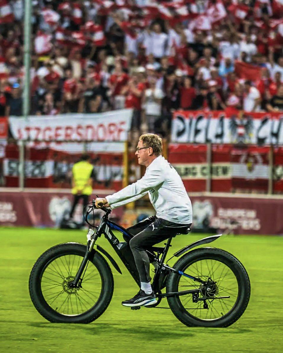 Ralf Rangnick cycles across the pitch before Austria v Bosnia