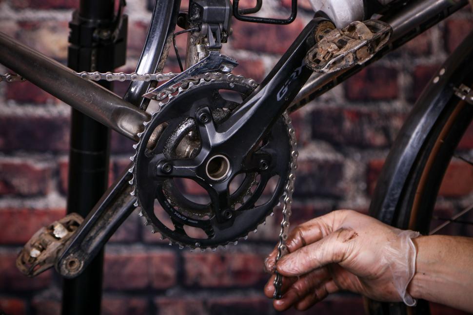 Replacing a bike chain - 21 - routing the new chain through the front mech and around the large chain ring.jpg