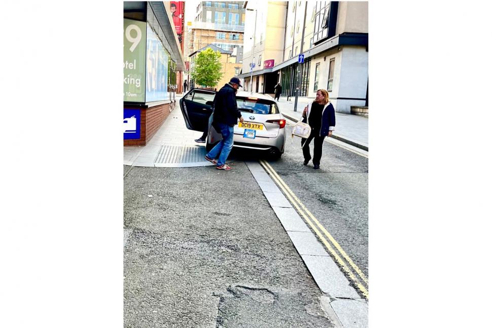 Taxi on pavement in Sefton