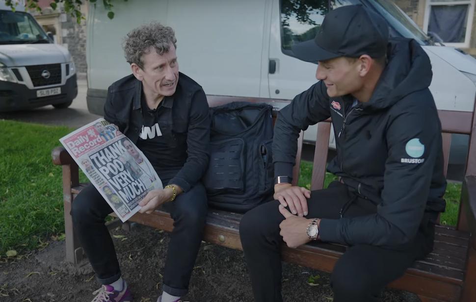 Van der Poel gifted newspaper (screenshot, Zwift Youtube video)