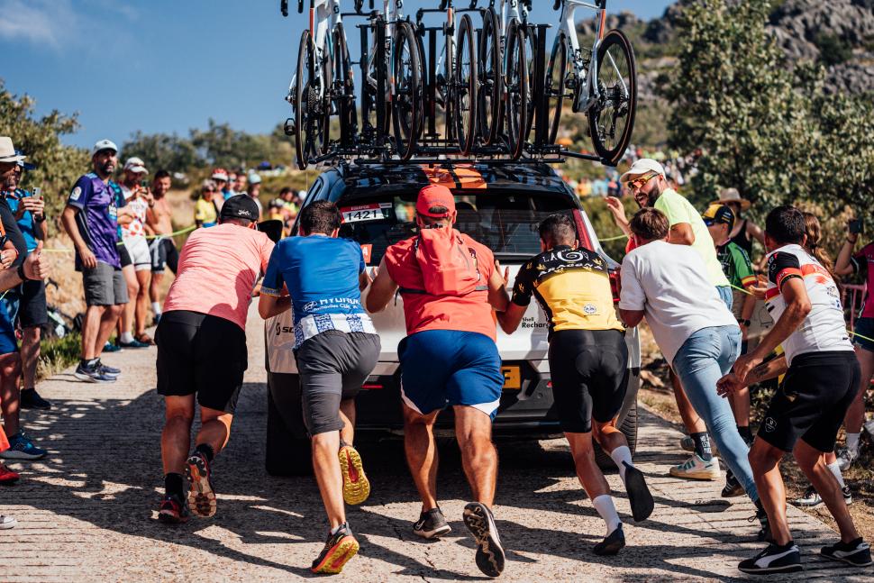 Fans give DSM-Firmenich car a push on final climb of stage four, 2024 Vuelta a España (Zac Williams/SWpix.com)