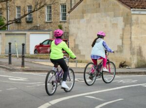 Two young cyclists riding in hi-vis and helmets, Kent Road Safety campaig