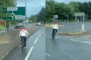 Police investigate viral video of adult cyclist carrying child